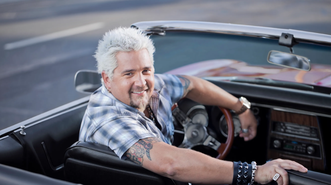 The People’s Chef
 
Another reason that Guy Fieri became so successful is that, in almost every sense, he is “the people’s chef.” And we’re not just talking about how different he is from his Food Network colleagues. Amid a sea of snobby, elite foodies, Fieri’s mission to highlight “real food for real people” has made him that much more popular.
 
But the real magic of Fieri comes from what he focuses his attention on. For example, the entire point of Diners, Drive-Ins, and Dives is to focus on little “mom and pop” style establishments that don’t often get much attention or love. Very often, an appearance on Fieri’s show helps to make these local businesses more successful than ever.
 
Oh, and Fieri also hosts another show…a competitive grocery-themed game show called Guy’s Grocery Games. All of the food bought for the show that is not used gets donated to local food banks that really need it.