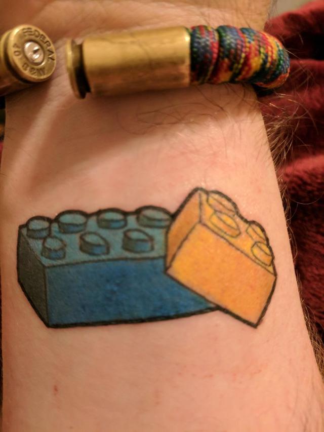 Got My First Tattoo Today. The Big Brick Is To Represent My Big Brother Who Died One Day Shy Of His 40th Birthday This Year, In His Favorite Color, And The Little One (Hugging The Larger One) Represents Me, In My Favorite Color. We Always Built Lego Together