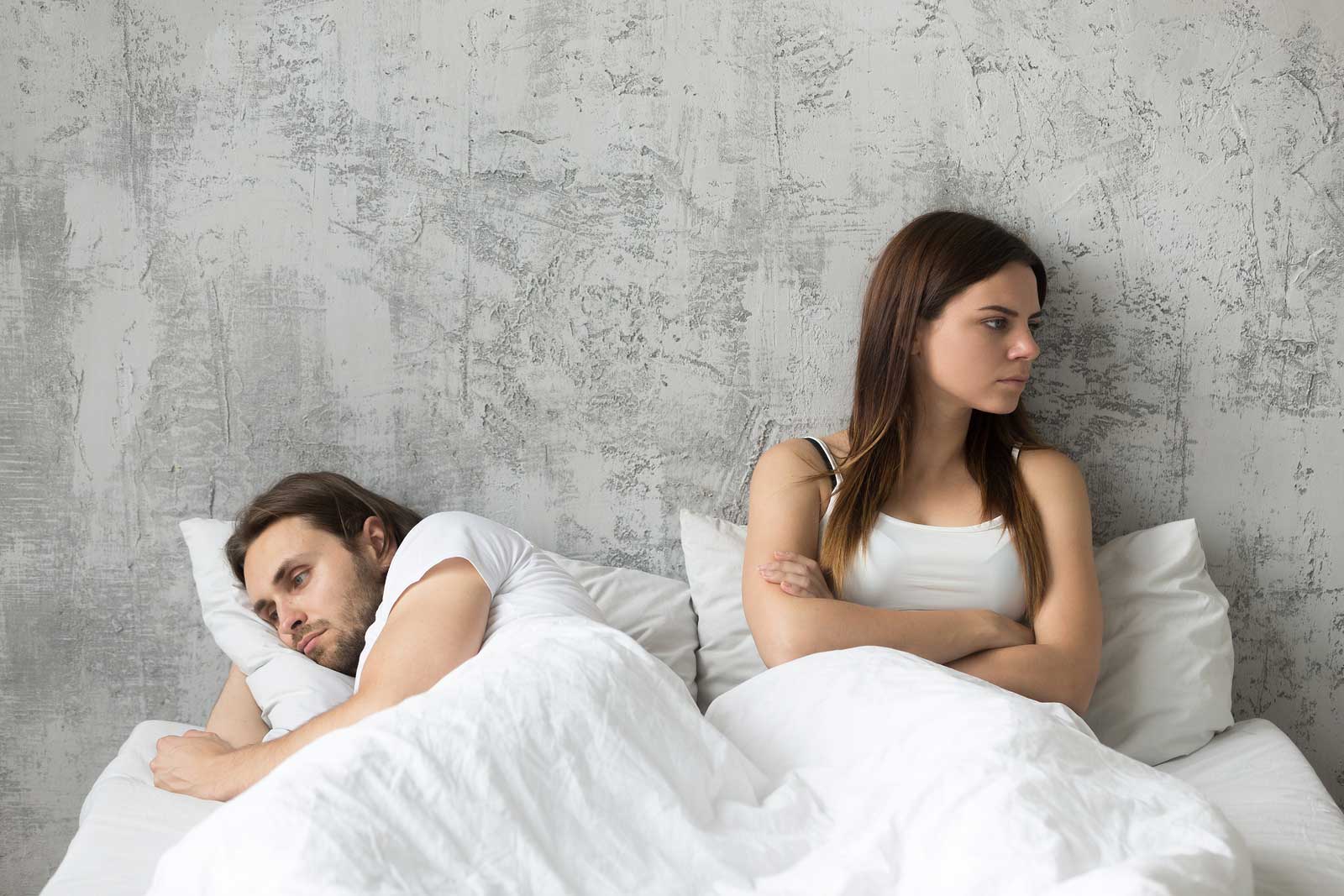 thigns women want men to know - sad couples on bed