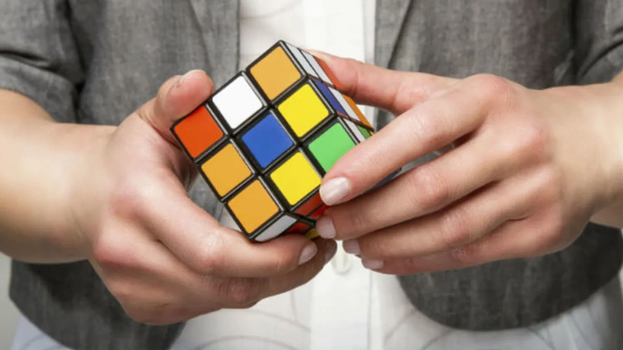 Skills That Are Easier To Learn Than You Think - person solving rubik's cube
