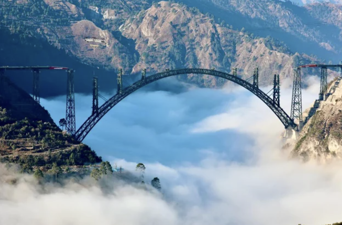 The world's highest arch bridge reaches over the clouds.