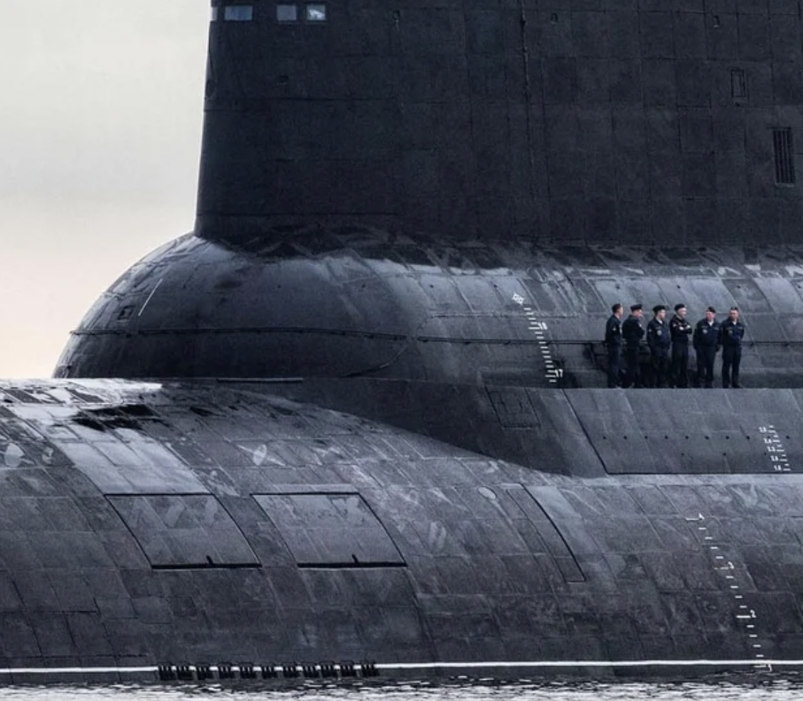 Sailors standing outside of a Russian submarine.