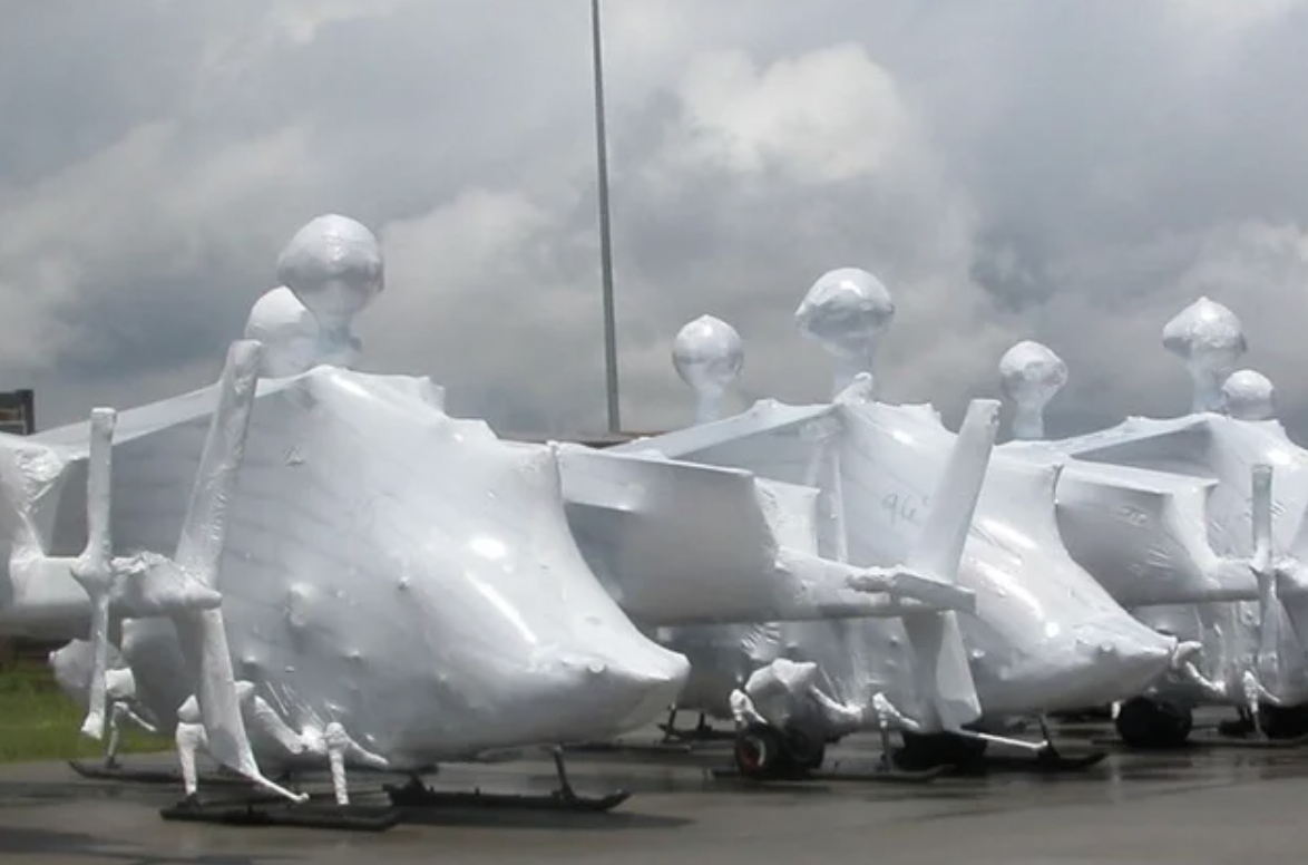 Helicopters get shrink-wrapped before being transported.