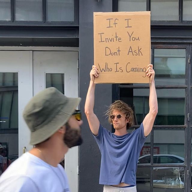 dude with sign 19