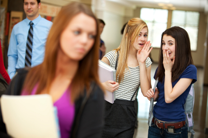 girls gossiping at school
