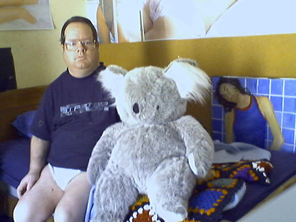 Creepy myspace profile pic of a diaper clad man and a large stuffed koala bear.