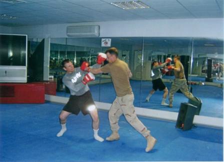 Two soldiers learning to box in Iraq.