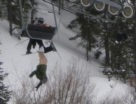 Man hanging from ski lift