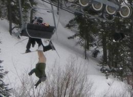 Man hanging from ski lift