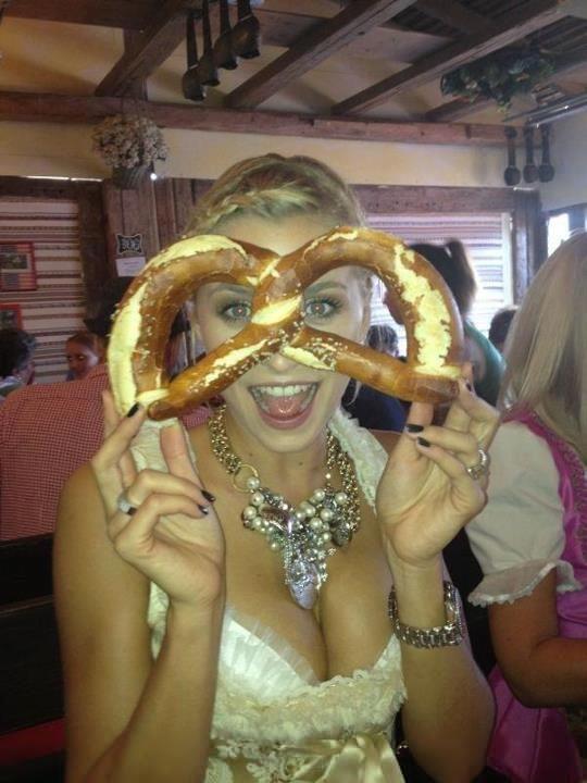 Hot girl at Oktoberfest holding a pretzel