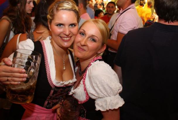 Hot girls at Oktoberfest holding beers