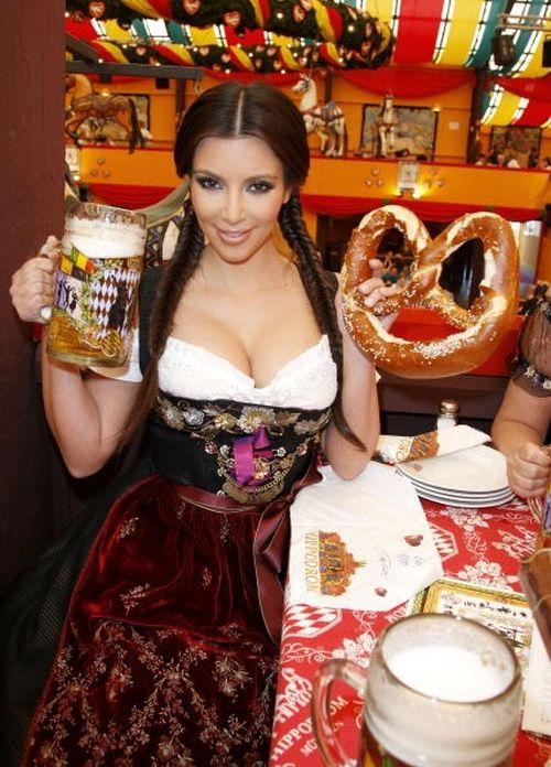 Hot girl at Oktoberfest with a beer and a pretzel