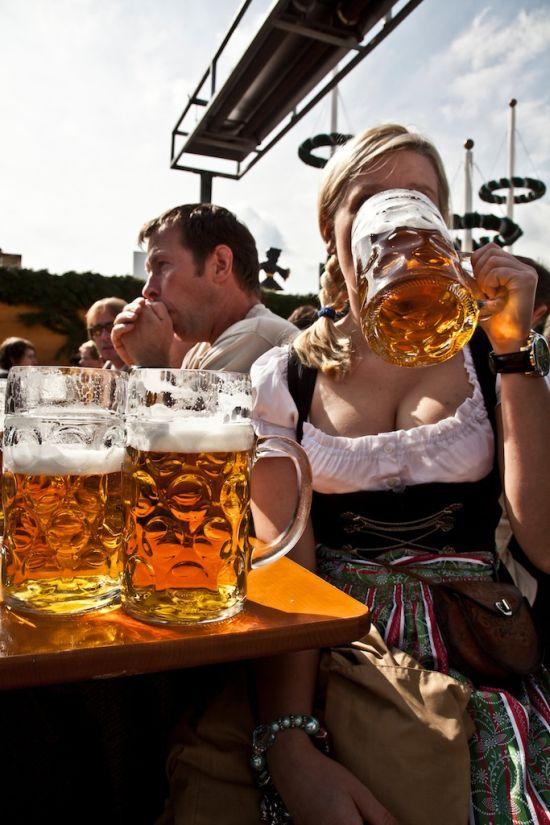 Hot girl with cleavage drinking a beer at Oktoberfest