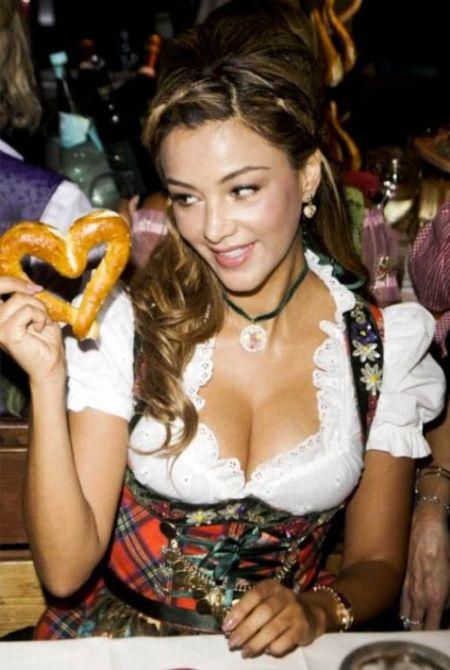 Hot girl at Oktoberfest with a pretzel