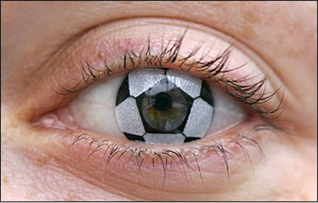 Keep your ball on the eye: German optician Stephanie Berndt shows off a soccer ball contact lens in Munich. The lens is paired with a German flag lens in a set that sells for $54