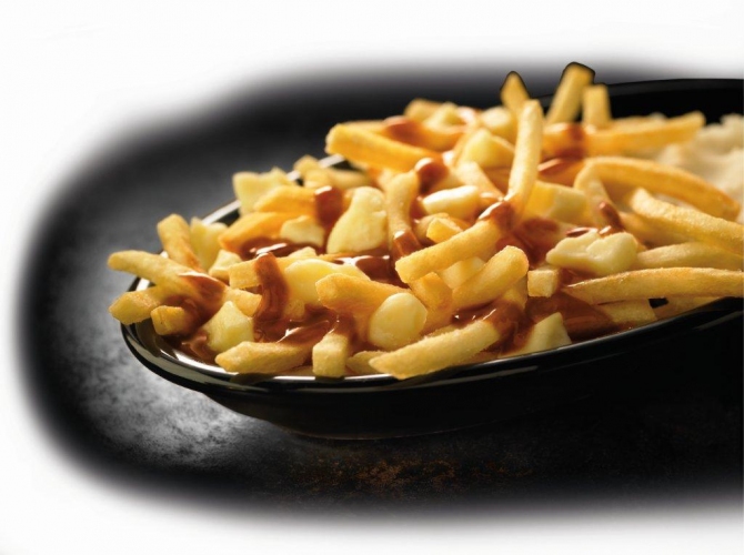 Canada has taken a twist on McDonald's delicious fries. Poutine has gravy and cheese curds drizzled over fries. Sounds like it belongs on a food cart ASAP