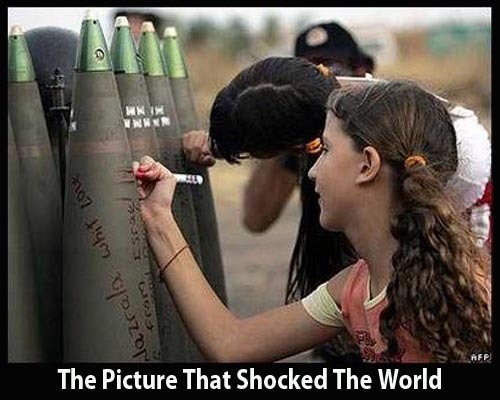 Israeli children writing on munitions.