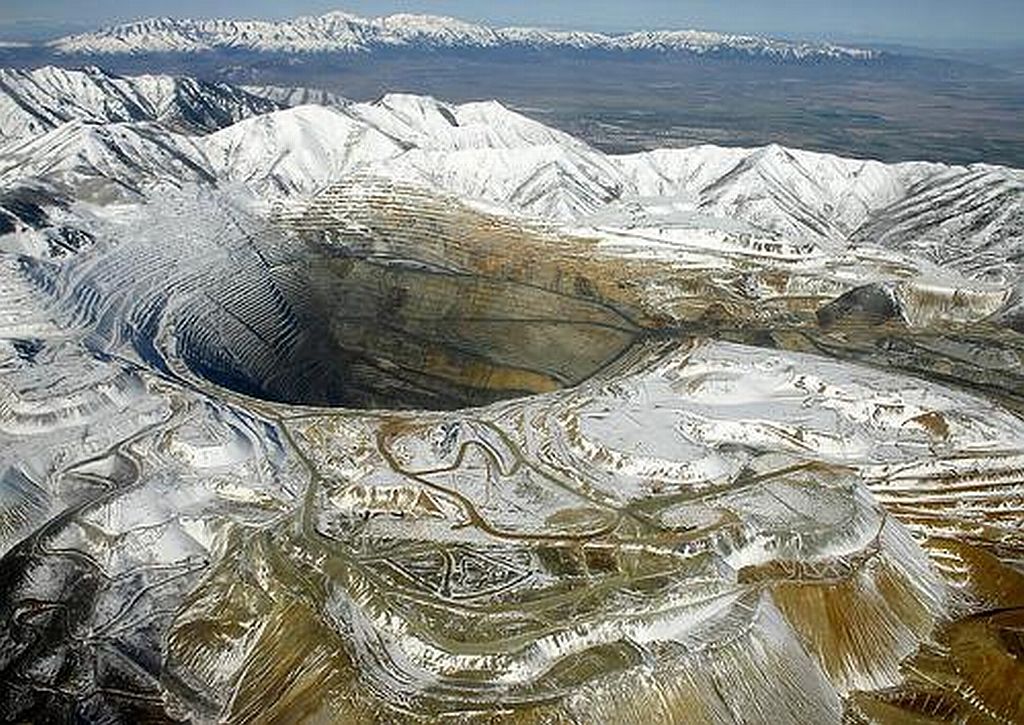 Bingham Canyon Mine, Utah.  Largest man-made in the world began in 1863 and still continues today. It's several miles deep and 2.5miles wide.