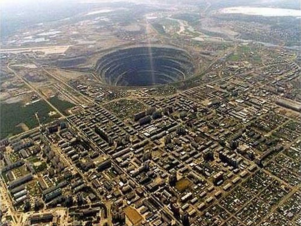 Mirny Diamond Mine, Serbia.  This beast is the largest open mine in the world. 525meters deep, 1200meter diameter at top. There's a no-fly zone above it due to incidents of lost helicopters!