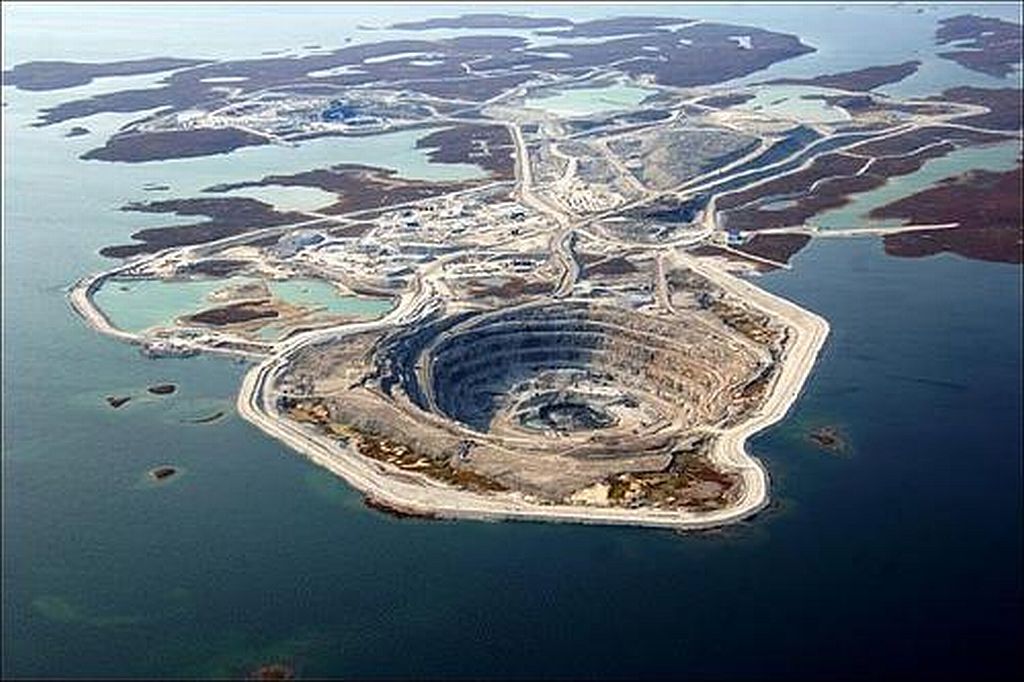 Diavik Mine, Canada.  This mine is so huge and in such a remote area that it has its own airport with a runway large enough for a Boeing737. It's looks just as awesome when the surrounding water is frozen.