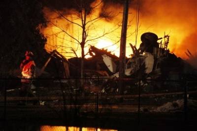A plane burns after it crashed into a house in Clarence Center, N.Y., Thursday Feb. 12, 2009. Authorities say it was Continental Airlines Flight 3407 operated by Manassas, Va.-based Colgan Air.