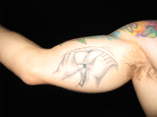 A tattoo featuring an anus. Photo by Duncan Creamer. Check out his <a href="http://www.flickr.com/photos/creamaster/1551784879/">Flickr!</a>