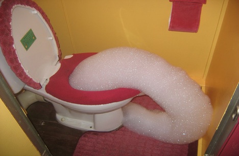 A toilet with foam coming out of it. Wow.