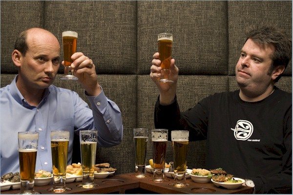 Two men looking at beers while doing a beer tasting