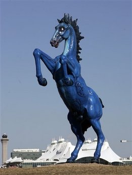 The 32-Foot blue 'Mustang' sculpture is seen at Denver International Airport with the terminal in the background