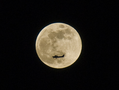 A Cessna Airplane Captured On Film Passing In front Of The Moon.