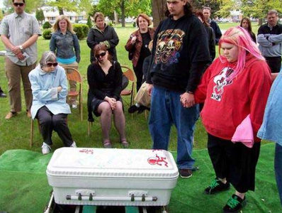 sad that children die, but......
1 who dresses like they just came from a iron maiden concert at a funeral?
2 and honor your child's passing by placing stickers on the casket? really?
3 and who in the hell brings a camera to a funeral?
