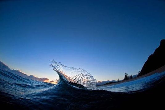 like a glass sculpture, the waves crash together at Kaena Point in Oahu, Hawaii