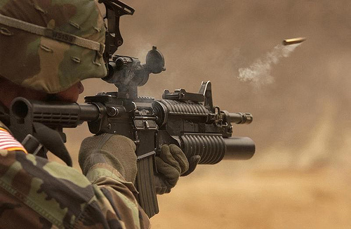 Soldier firing his rifle