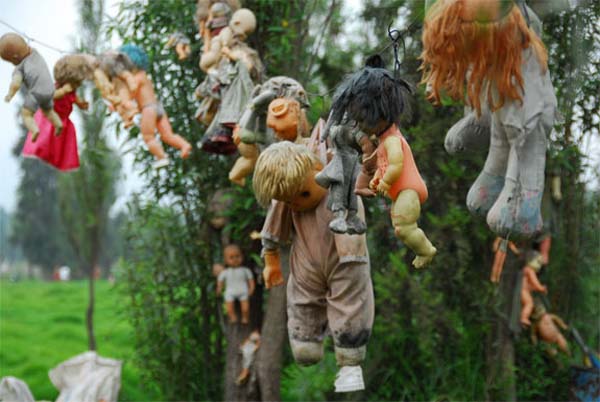 Once upon a time, the legends say, a little girl drowned in a canal surrounding an uninhabited island in Mexico. Days after they found the body, dolls began to float to the island. No one is 100 sure where the dolls came from. But today, they hang from trees. Now the area is nicknamed Island of the Dolls.