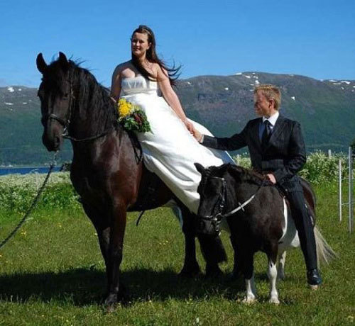 What a gentlemen -- chivalry clearly isn't dead. This groom lets his wife ride the big horse while he himself opts for the little pony. Or is that a donkey?