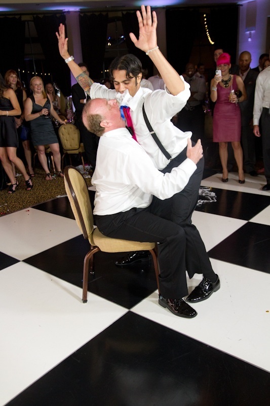 These two guys got a little crazy on the dance floor and decided to engage in a mouth-to-mouth napkin pass. Looks like it's got the other guests pretty pumped up!