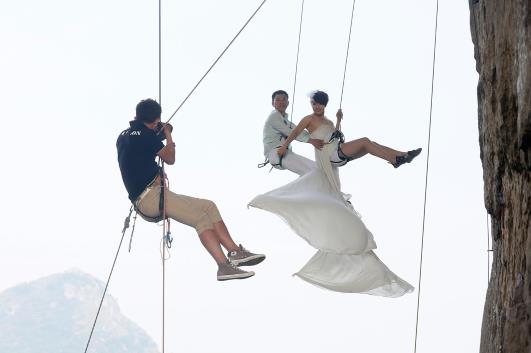 Rock climbing bride and groom