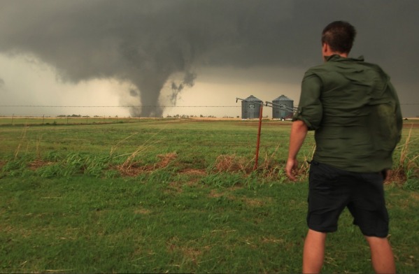 Fastest Winds Ever! - The fastest winds recorded on Earth are not surprisingly the ones moving around inside the funnel of a tornado. Speeds of up to 300 mph have been recorded! If we were this guy in the photograph, we certainly wouldn't be standing there like that! Looks like it is time to run in the other direction, buddy...