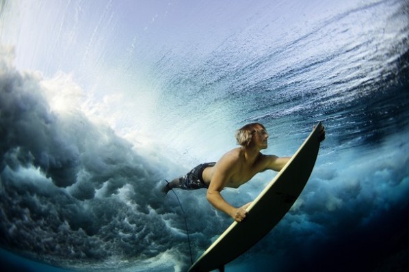 Underwater Surf - 'Underwater Surf' was photographed by Lucia Griggi. She explains, "Taken at Cloud Break at an outer reef in Fiji, a surfer duck dives his board to clear the rolling waves of the raw ocean."