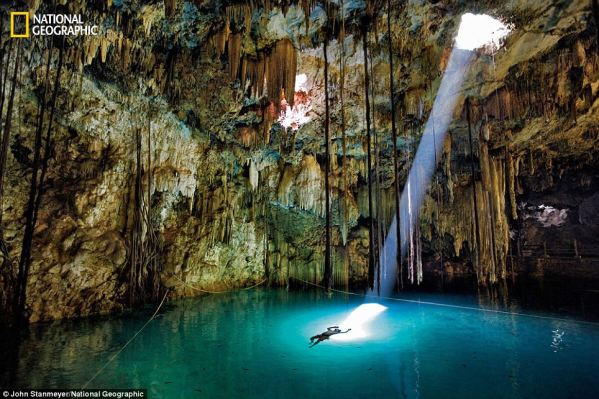 The Underworld - This stunning photograph was taken by John Stanmeyer in 2010. It depicts the sun beaming on a lone swimmer a natural well in the Yucatn thought by the Maya to lead to the underworld.