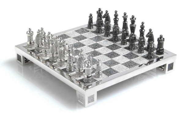 This hand-made chess set features 9900 black and white diamonds and is set in 14-carat white gold. It was designed by Bernard Maquin and is part of the Charles Hollander Collection. The set weighs a total of 186.09 carats!