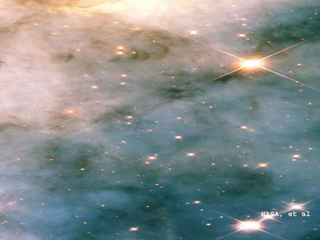 Dramatic dark dust knots and complex structures are sculpted by the high-velocity stellar winds and high-energy radiation from the ultra-luminous variable star called Eta Carinae. This image shows a region in the Carina Nebula between two large clusters of some of the most massive and hottest known stars. This NASA Hubble Space Telescope close-up view shows only a three light-year-wide portion of the entire Carina Nebula, which has a diameter of over 200 light-years. Taken with Hubble's Wide Field Planetary Camera 2 in July 2002, this color image is a composite of ultraviolet, visible, and infrared filters that have been assigned the colors blue, green, and red, respectively.