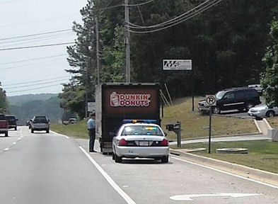 I wonder if the guy in the donut truck actually broke the law or if the cop was just hungry? 
