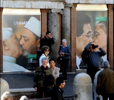 People walk past ads in Paris featuring French President Nicolas Sarkozy, far right, kissing German Chancellor Angela Merkel, and Israeli Prime Minister Benjamin Netanyahu, second from left, kissing Palestinian President Mahmoud Abbas.