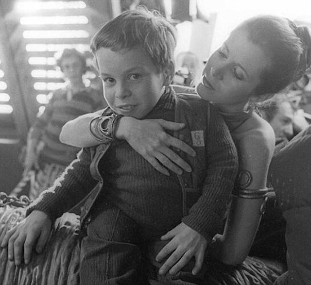 Peter Mayhew, who played Chewbacca in the original Star Wars, took to Twitter Thursday night and unleashed a veritable trove of annotated behind-the-scenes photos from the original trilogy. Some of these shots you'll no doubt recognize, but many of them were new to us  like this ridiculously adorable photo of 11-year-old Warwick Davis! Fisher is probably confused by the fact that Davis is a little person, assumes he is 6 years. old. Meanwhile you know 11 year old Davis is like, "Oh yeah!"