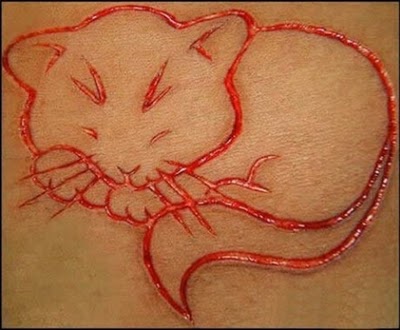 carving scarification spider tattoos