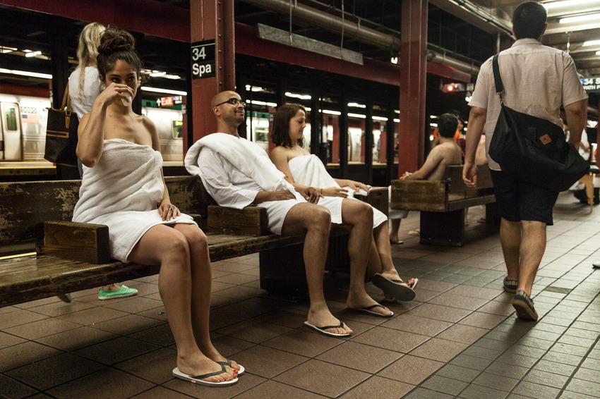 Complete with lemon and lime-infused water, towel service, sauna benches, hot stone massage and a makeshift "steam room," the improv group turned the subway platform into a midscale spa.