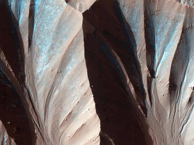 This image was taken by the High Resolution Imaging Science Experiment HiRISE flying onboard the Mars Reconnaissance Orbiter mission.Gully landforms like those in this image are found in many craters in the mid-latitudes of Mars. Changes in gullies were first seen in images from the Mars Orbiter Camera in 2006, and studying such activity has been a high priority for HiRISE. Many examples of new deposits in gullies are now known.