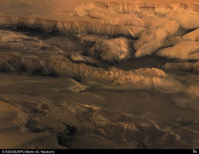 Valles Marineris Latin for Mariner Valleys, named after the Mariner 9 Mars orbiter of 197172 which discovered it is a system of canyons that runs along the Martian surface east of the Tharsis region. At more than 4,000 km 2,500 mi long, 200 km 120 mi wide and up to 7 km 23,000 ft deep,