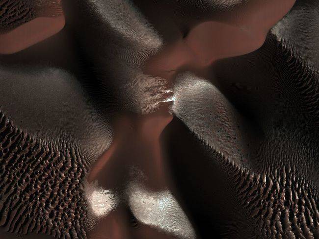 Dunes within a crater on Mars are visible in this image. This crater is located in the Southern hemisphere where it was winter at the time this image was taken.